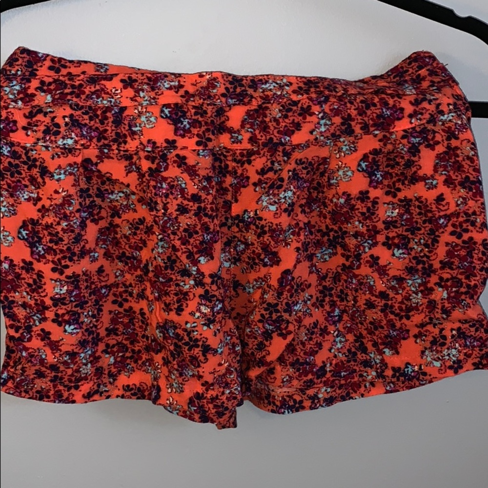 Orange and floral pattern shorts.